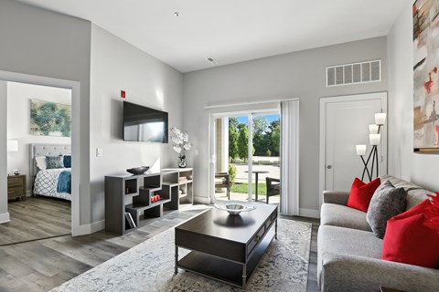 A modern living room with a grey couch and a coffee table.