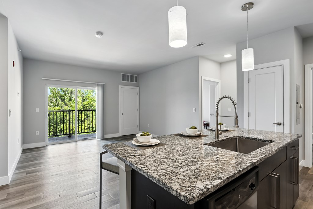 A kitchen with a granite countertop and a sink.