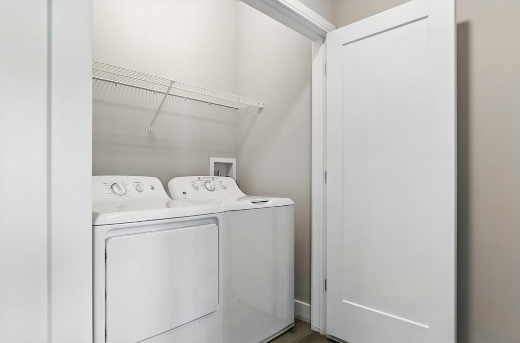 A white washing machine and dryer in a laundry room.