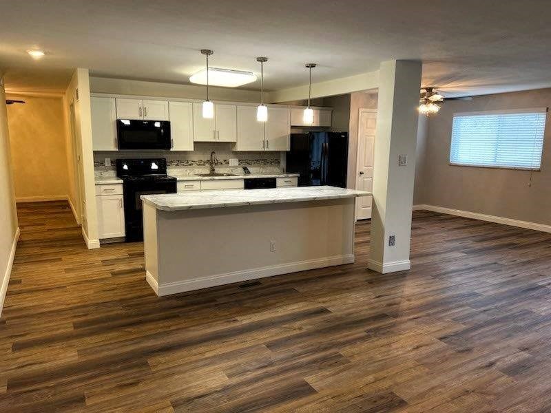 an empty kitchen with an island in the middle