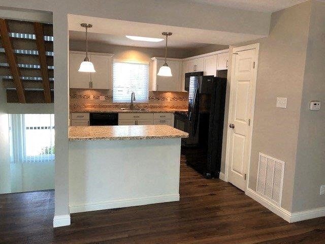 a kitchen with an island in the middle of it