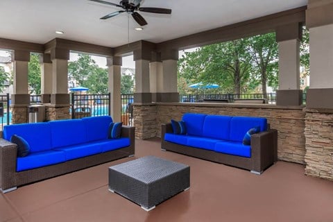 a living room with blue couches and a table