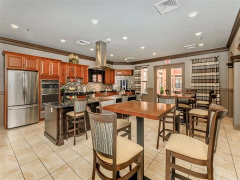 a kitchen with a table and chairs in front of a counter