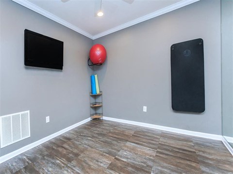 a living room with a tv and a red ball on the wall