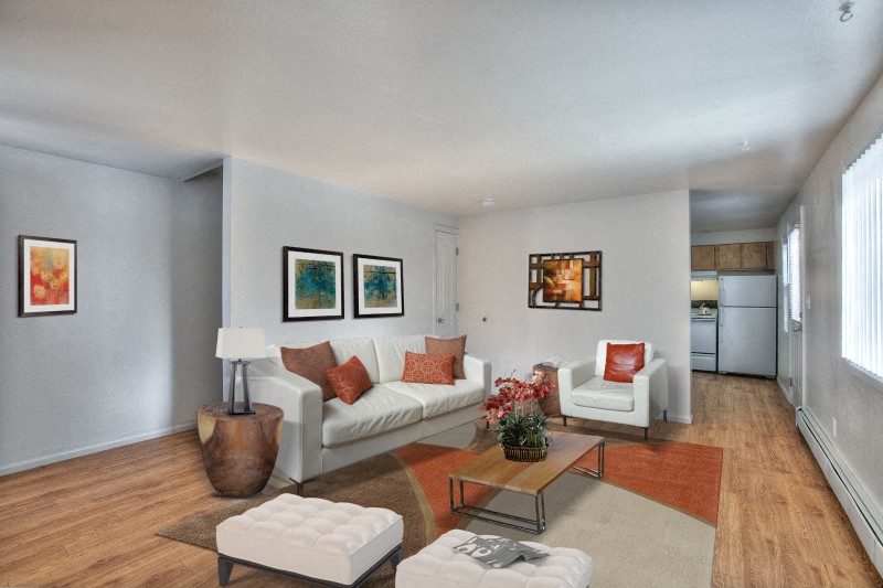 A living room with a white couch and a coffee table.