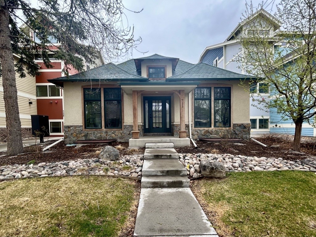 A house with a stone pathway leading to the front door.