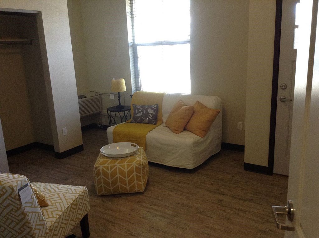 a living room with a couch and a window