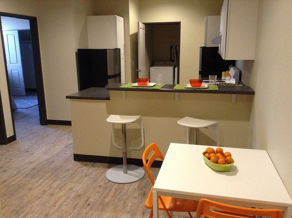 an empty kitchen and dining room with a table and chairs