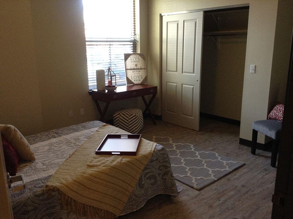 a bedroom with a bed and a tablet on top of it