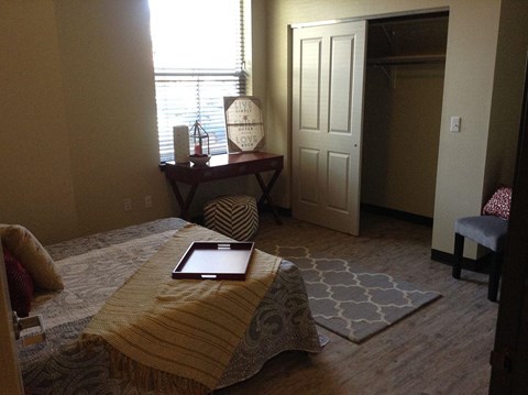a bedroom with a bed and a tablet on top of it