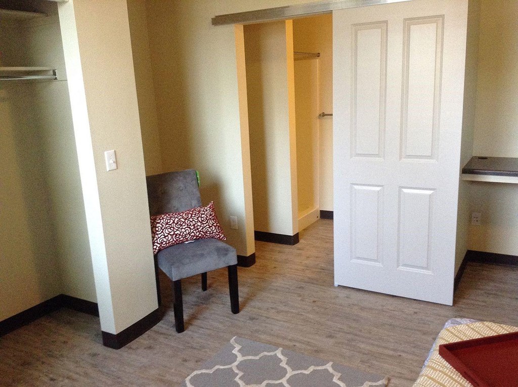 a living room with a chair and a door