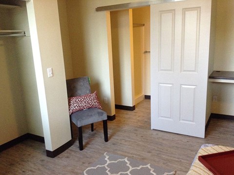 a living room with a chair and a door