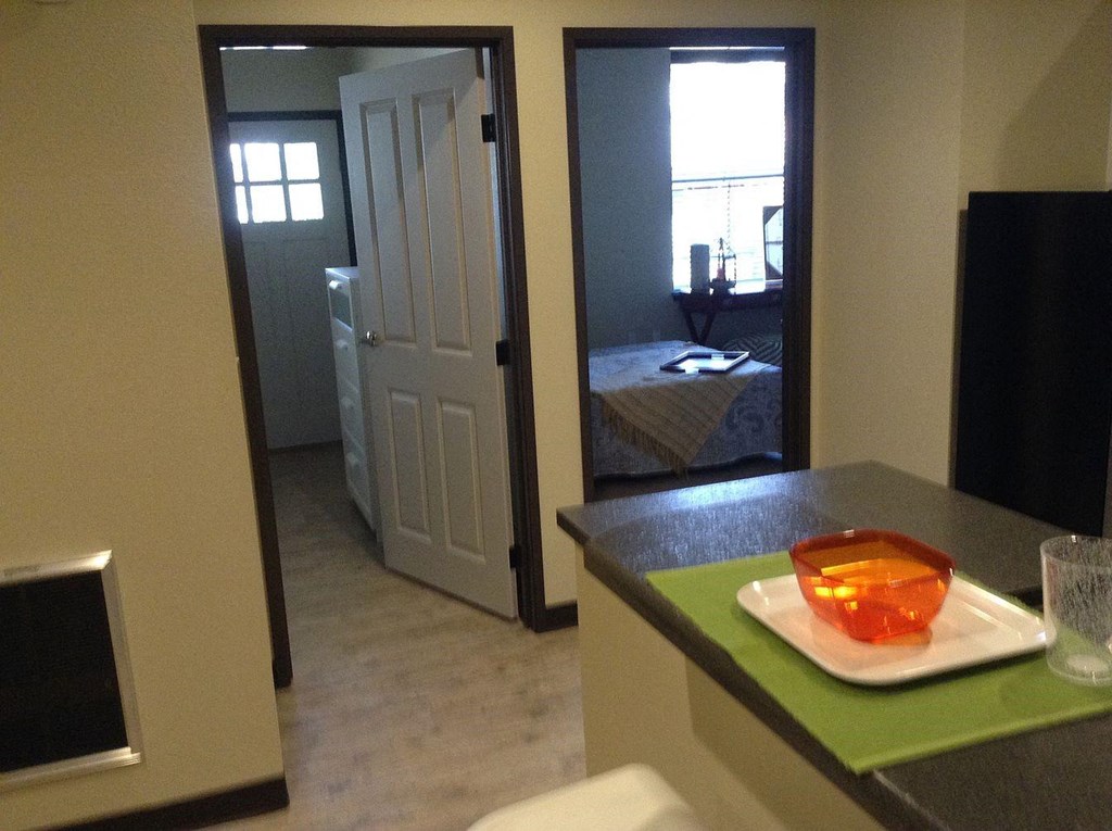 a view from the kitchen into the living room and bedroom