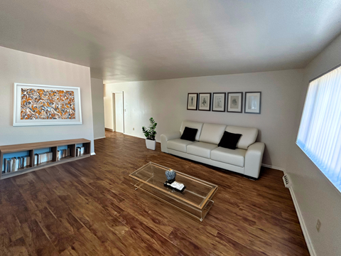 A living room with a white couch and a coffee table.