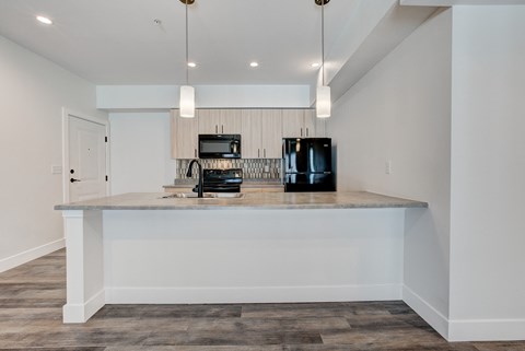 A kitchen island with a microwave and a coffee maker on it.