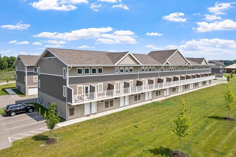 A large building with a parking lot in front of it.