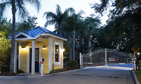 a small house with a gate and a driveway