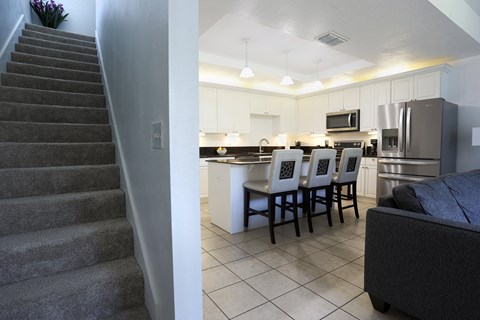 a view of the kitchen and dining area from the stairs into the living room