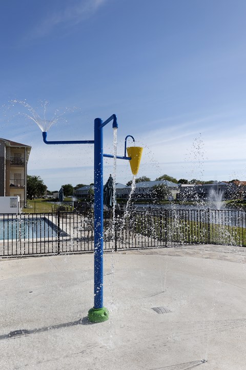 the water fountain at the pool is spraying water into the air