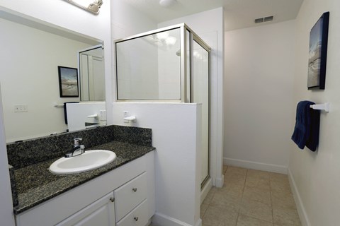 a small bathroom with a sink and a shower