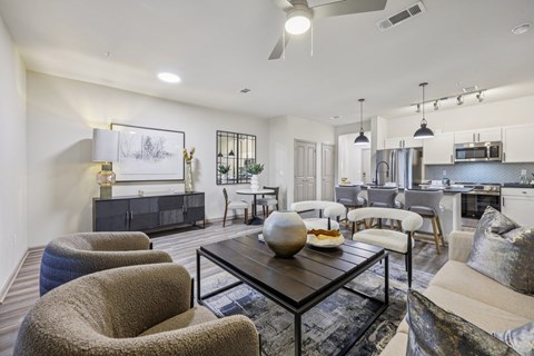 A modern living room with a grey sofa and a black coffee table.