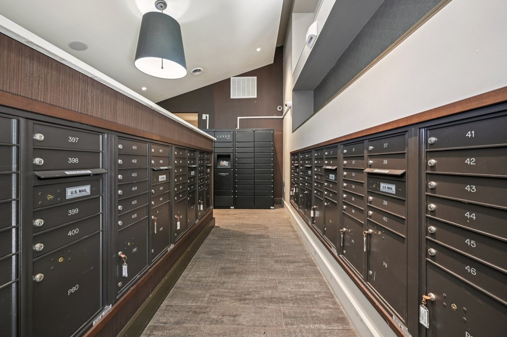A long hallway with mailboxes on both sides at Everra Midtown Park Apartments, Dallas