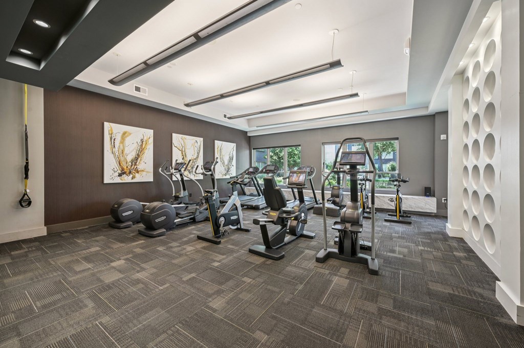A gym with a variety of exercise equipment at Everra Midtown Park Apartments, Dallas, TX, 75231