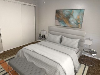 A bedroom with a large bed and a painting on the wall.