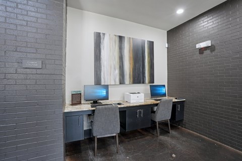 A room with a desk and two computers.