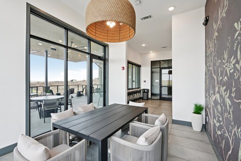 A modern dining room with a large table and chairs.
