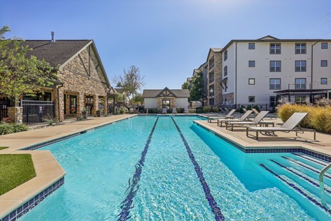 A large swimming pool with lane dividers and sun loungers.