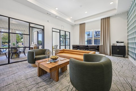 A modern living room with a large grey armchair and a wooden coffee table.
