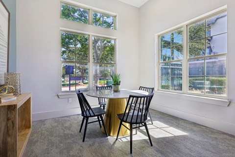 A dining room with a round table and chairs.