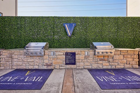 A wall with a V on it and two grills on top.