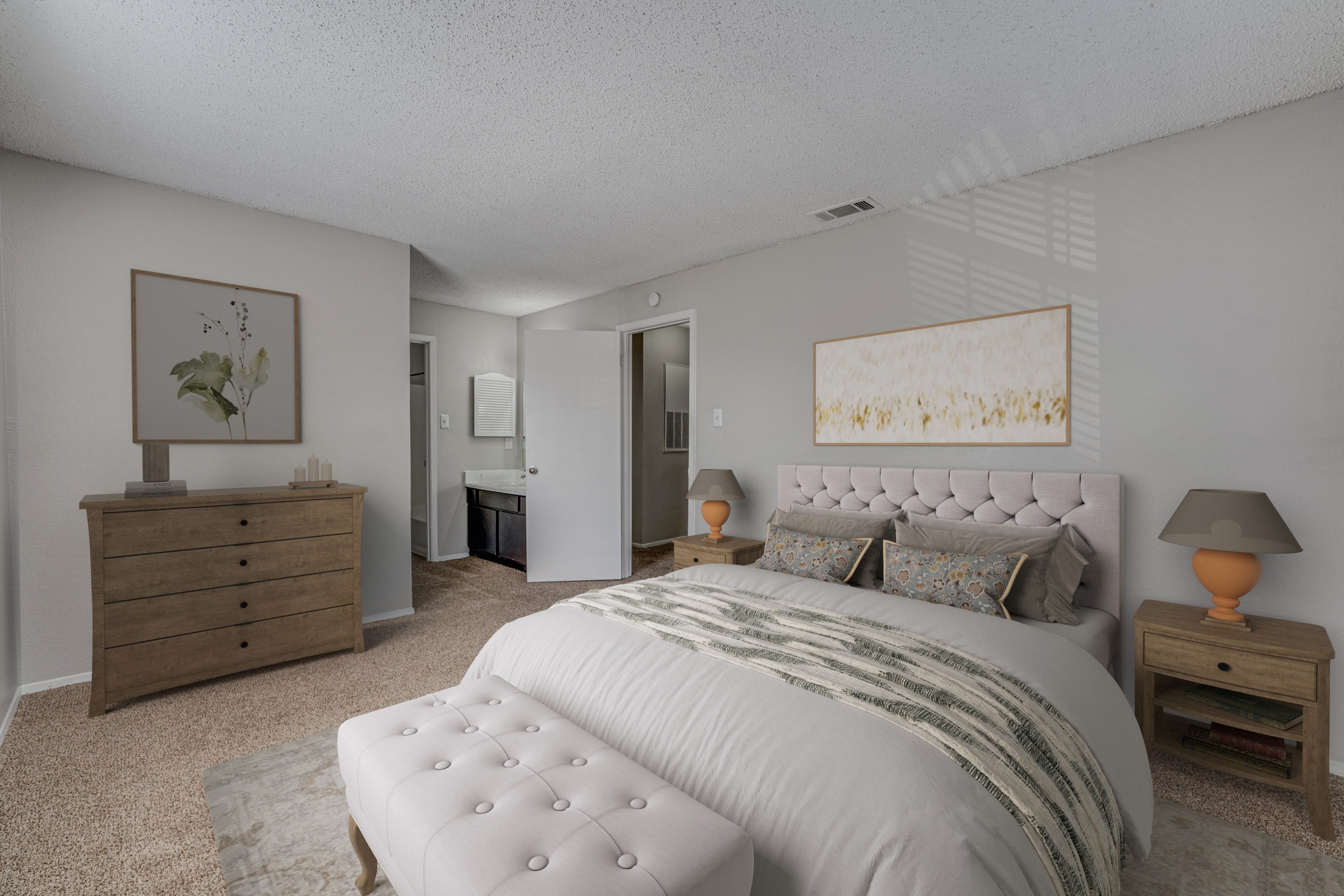 A bedroom with a large bed, a dresser, and a nightstand with a lamp.