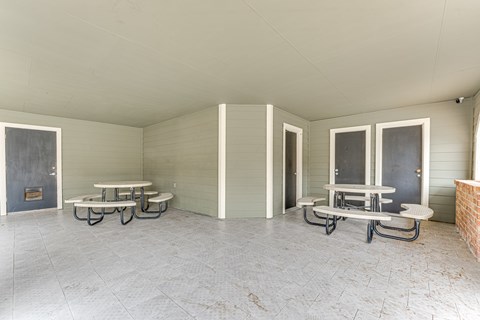A room with a concrete floor and a fireplace.