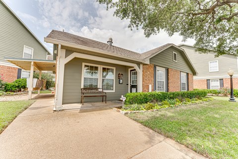 A house with a grey roof and a brown door.