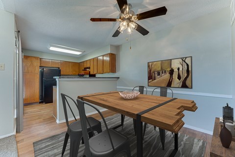 A dining room with a wooden table and chairs.
