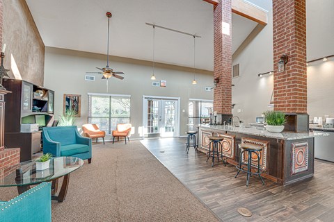 A modern kitchen with a bar and seating area.