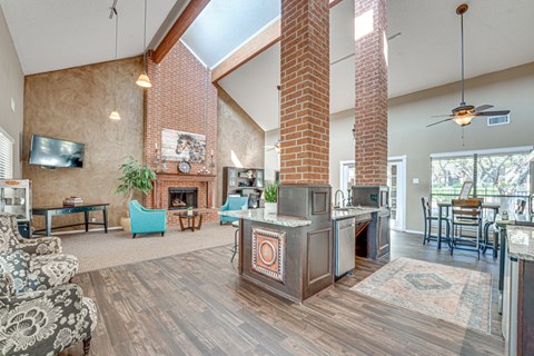 A living room with a fireplace and a TV on the wall.