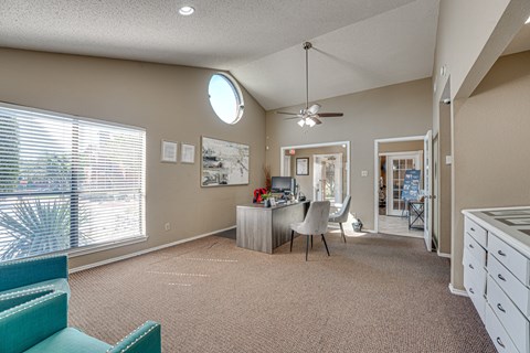 A room with a desk and a chair in it.