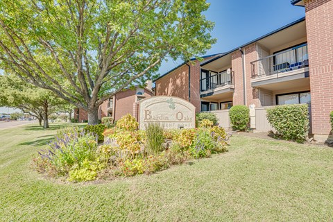 A building with a sign that says Berdine Oaks in front of it.
