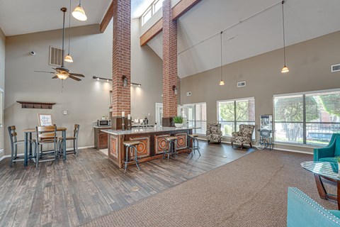 A living room with a kitchen area in the background.