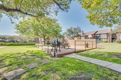 A park area with a bench and a sculpture.