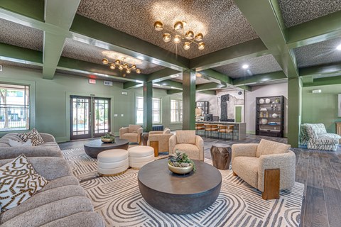 A living room with a large coffee table and a variety of seating options.