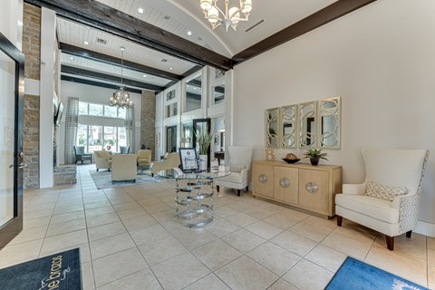 A spacious living room with a large rug on the floor.