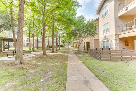 sidewalk in front of apartment buildings. at The Brazos, Dallas, Texas