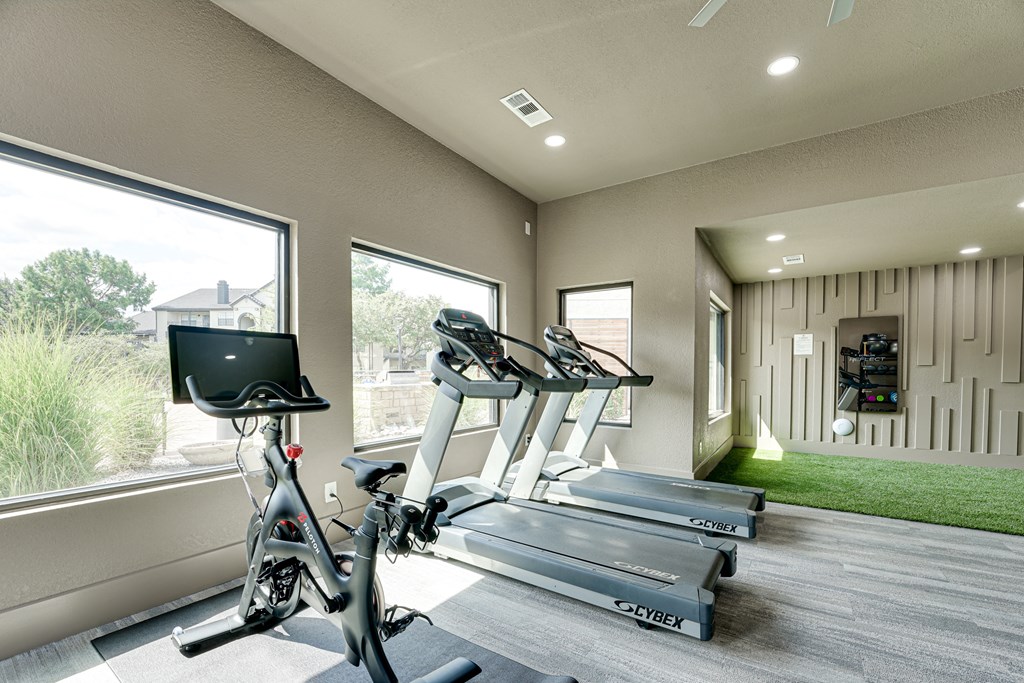 a home gym with treadmills and exercise bikes  at Carmel Creekside, Fort Worth