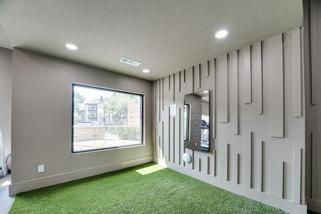 a room with green carpet and a large window  at Carmel Creekside, Fort Worth, TX