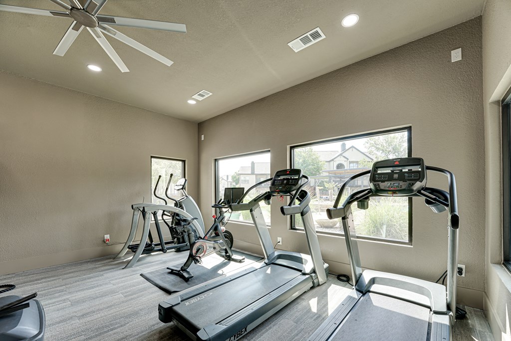 a home gym with treadmills and elliptical trainers  at Carmel Creekside, Texas, 76137